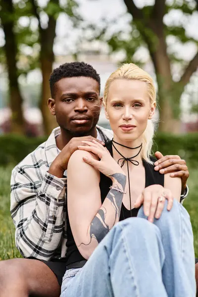 Multicultural couple, African American man and Caucasian woman in a park. — Stock Photo