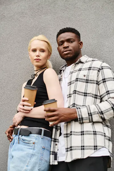 A multicultural man and woman standing next to each other on an urban street, sharing a moment of connection and togetherness. — Stock Photo