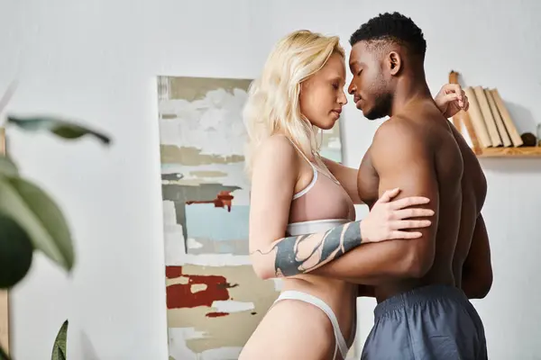A sensual moment captured as a multicultural boyfriend and girlfriend stand together in their underwear at home. — Stock Photo