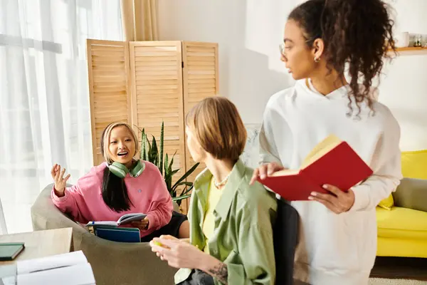 A diverse group of teenage girls engage in studying and bonding in a cozy living room setting. — Stock Photo