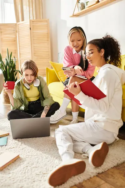 A group of interracial teenage girls studying and collaborating around a laptop, deepening friendships and education. — Stock Photo