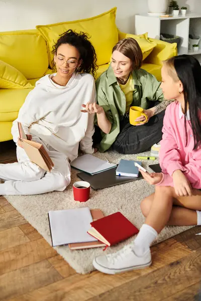 Multicultural teenage girls united in a circle, absorbed in studying literature and expanding knowledge from home. — Stock Photo
