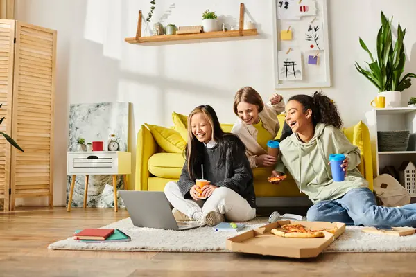 A diverse group of teenage girls relax on a bright yellow couch, sharing laughs and forming friendships. — Stock Photo
