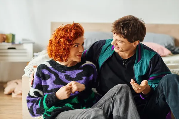 Good looking cheerful boyfriend and girlfriend in cozy outfits hugging each other warmly at home — Stock Photo