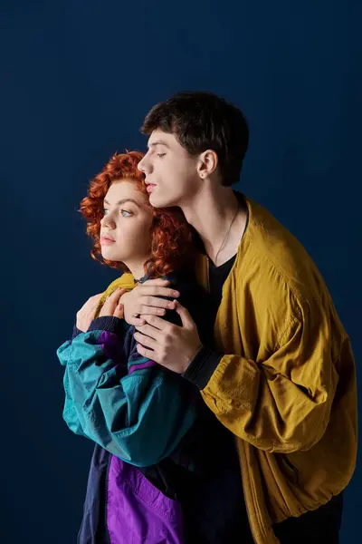 Good looking loving boyfriend and girlfriend in fashionable clothes posing together and looking away — Stock Photo