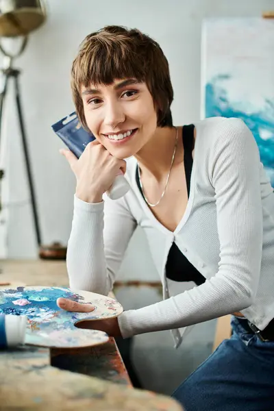 A woman sitting at a table, looking at camera. — Stock Photo