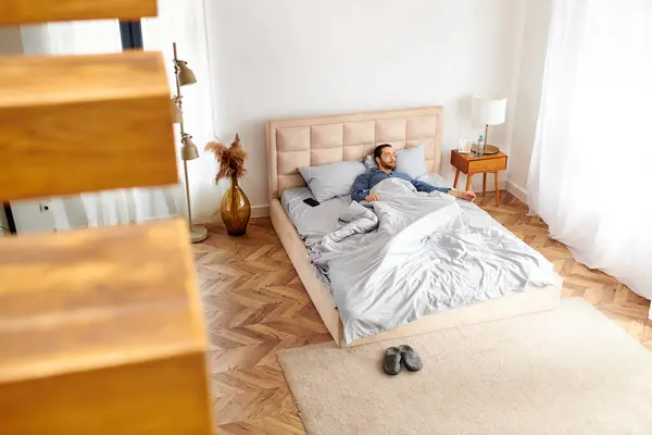 Hombre guapo acostado en la cama en el dormitorio. - foto de stock