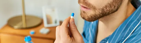 A handsome man taking pill. — Stock Photo