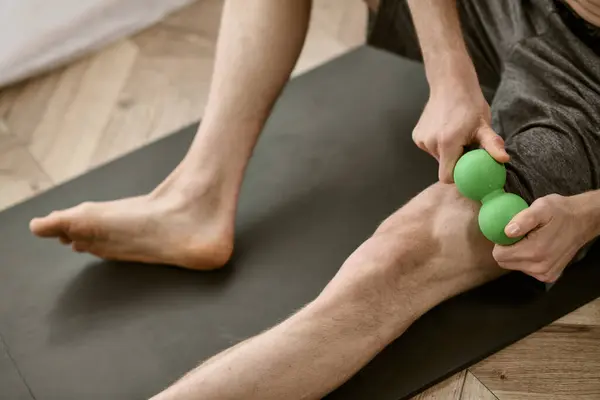 Handsome man practices yoga poses on mat at home. — Stock Photo