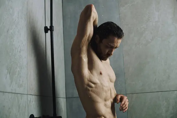 Handsome man showering at home. — Stock Photo
