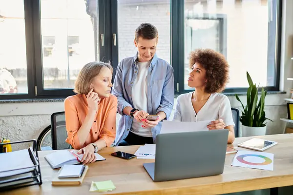 Diverse group of businesswomen working on laptop at table. — Stock Photo