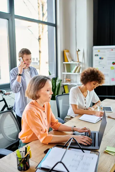 Diverse group of businesswomen working together on laptops at a table. — Stock Photo