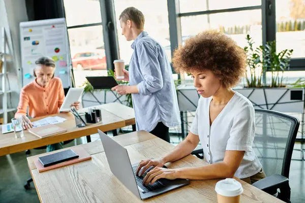 Women engrossed in work, at table in stylish setting. — Stock Photo