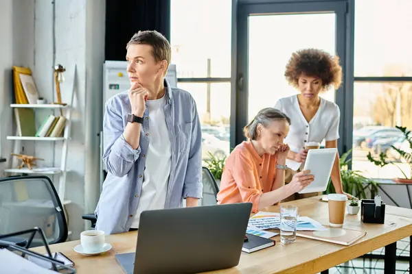 Hard working diverse group of businesswomen collaborating in their office. — Stock Photo