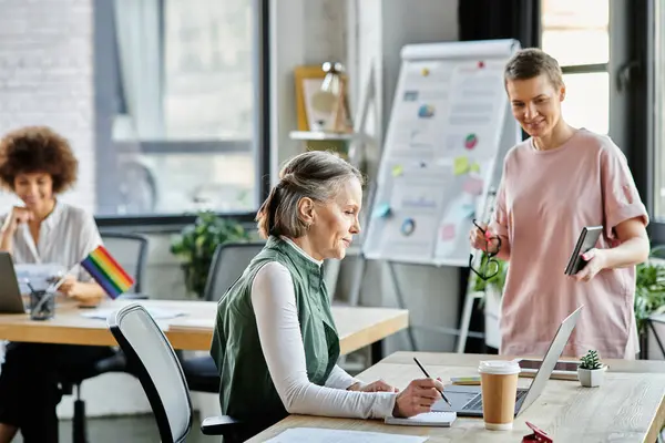 Dedicated diverse businesswomen discussing their project in office. — Stock Photo