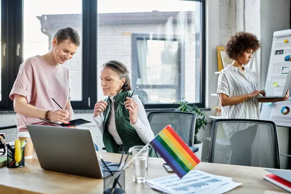 Amables y diversas profesionales que trabajan juntas en su proyecto en la oficina. - foto de stock