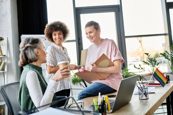 Cheerful diverse female professionals talking about their project in office. — Stock Photo