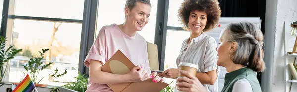 Merry diverse female professionals talking about their project in office. — Stock Photo