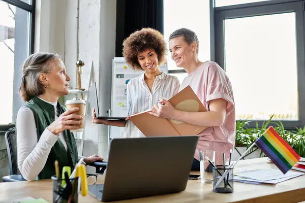 Attentive diverse female professionals talking about their project in office. — Stock Photo