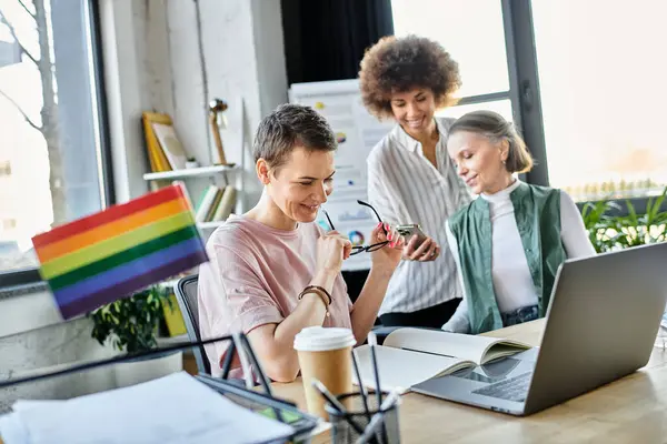 Dedicated diverse businesswomen discussing ideas at desk in modern office. — Stock Photo