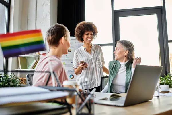 Jolly diverse businesswomen discussing ideas at desk in modern office. — Stock Photo