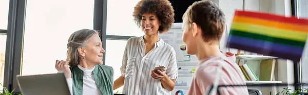 Merry diverse businesswomen discussing ideas at desk in modern office. — Stock Photo