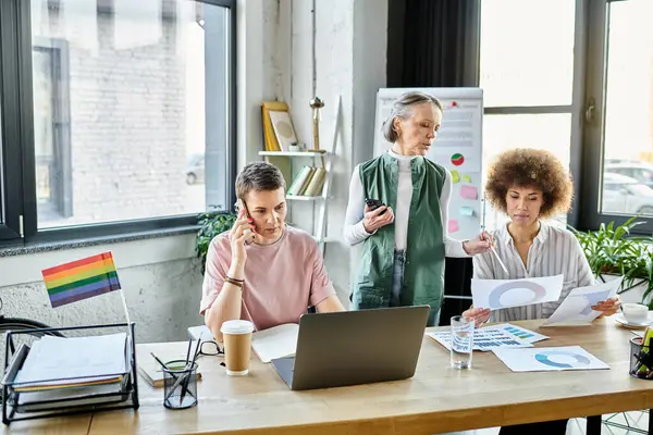 Enthusiastic diverse businesswomen, including members of the LGBT community, working together in an office. — Stock Photo