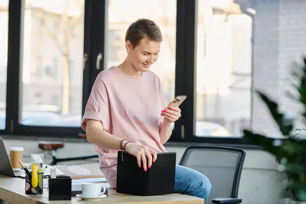 Engagierte Geschäftsfrau, die am Tisch in ihr Smartphone vertieft ist. — Stockfoto