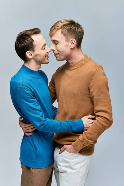 Two men in casual attire standing with arms around each other, showing love and connection. — Stock Photo