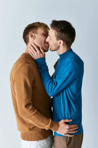 Two men, a loving gay couple, stand side by side on a white background. — Stock Photo