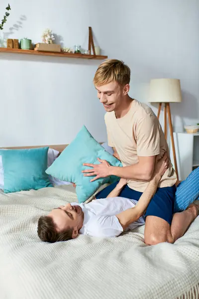 Un couple gay aimant, un homme étreignant son petit ami sur un lit. — Photo de stock