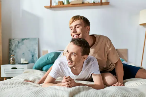 Two men in casual attire laying peacefully on a bed. — Stock Photo