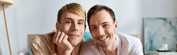 Two men in casual attire sitting closely together. — Stock Photo