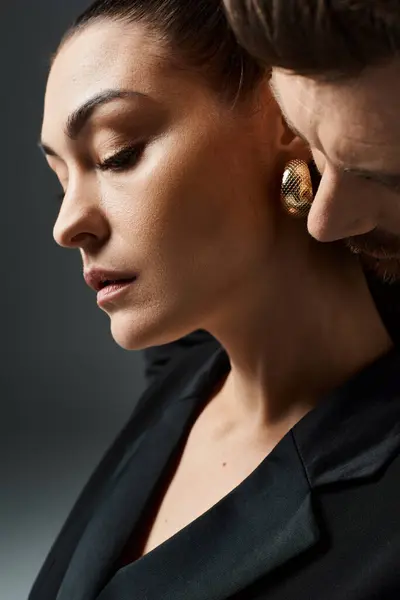 A loving, beautifully attired couple observing something in front of them. — Stock Photo