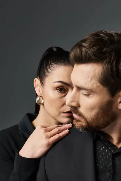 A man and a woman in stylish attire strike a pose together. — Stock Photo