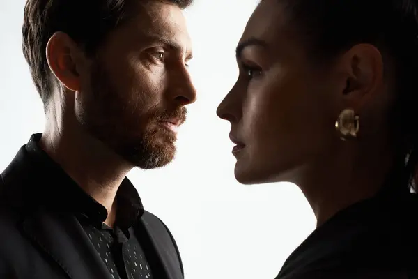 A man and a woman in elegant attire facing each other. — Stock Photo
