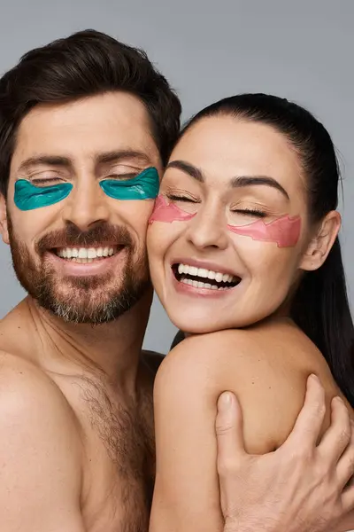 Alluring man and a woman using eye patches. — Stock Photo
