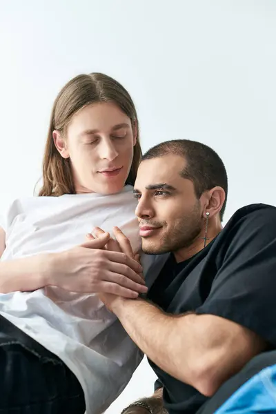 Two men sitting together on a bed. — Stock Photo