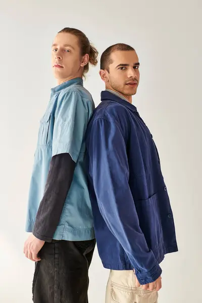 Two young men standing side by side, sharing a moment of connection. — Stock Photo