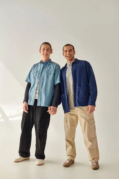 Two men in elegant attire stand together against a white backdrop. — Stock Photo