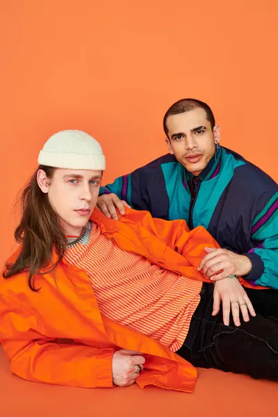 A loving gay couple sitting side by side. — Stock Photo