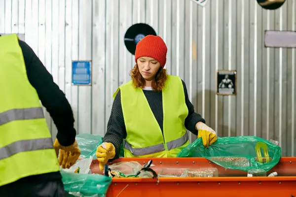 Young volunteers in yellow and green vests work together, sorting trash in an eco-conscious effort. — Stock Photo