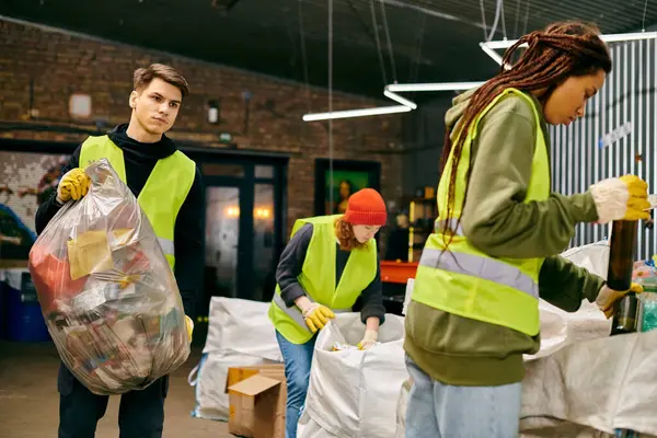 Young volunteers in gloves and safety vests sorting trash, working together to make a positive impact on the environment. — Stock Photo