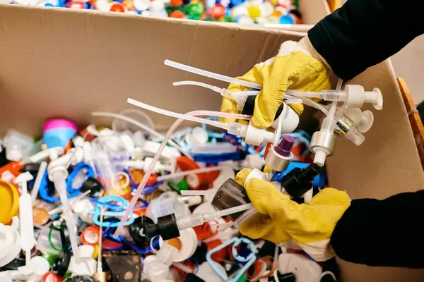 A collection of various plastic packed tightly inside a cardboard box, ready to be discovered and played with. — Stock Photo