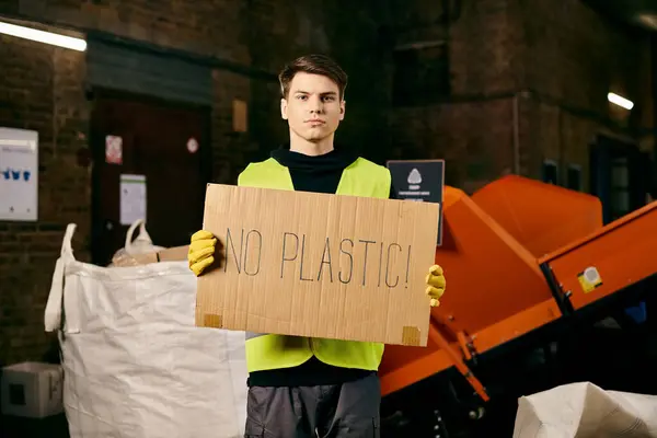 Young volunteer in gloves and safety vest advocates against plastic pollution by holding a sign that says no plastic. — Stock Photo