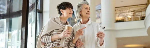 A tender senior lesbian couple standing together in a loving embrace. — Stock Photo