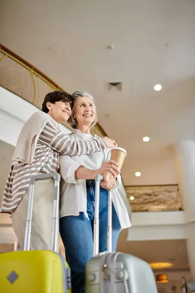 A loving senior lesbian couple standing gracefully by each other. — Stock Photo