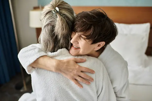 Tender moment between a loving senior lesbian couple in a hotel. — Stock Photo