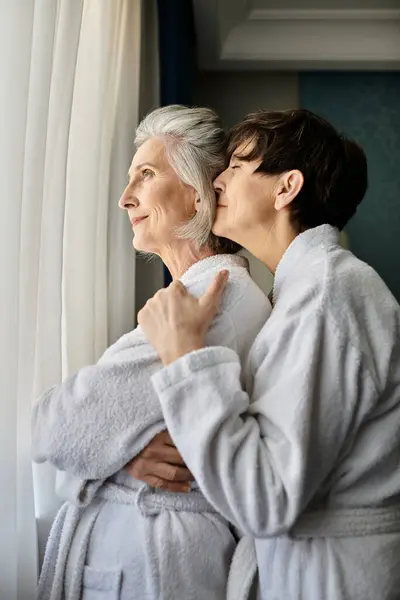Two senior lesbian women in elegant robes stand side by side. — Stock Photo