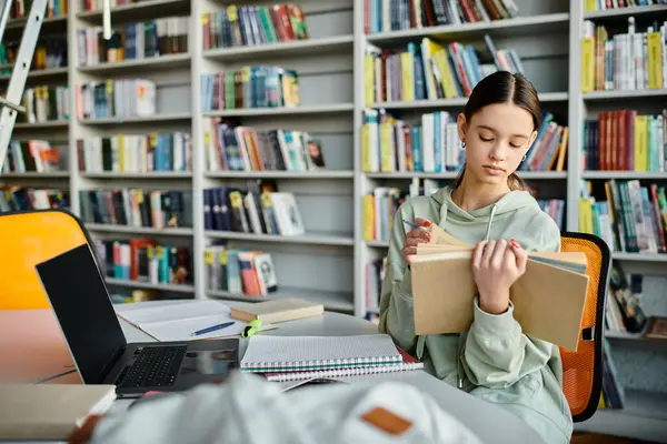 A teenage girl engrossed in a book at a library table, focused and immersed in her reading. — Stock Photo